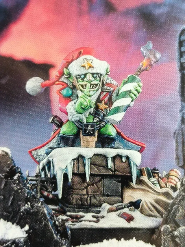 The Red Gobbo miniature — a green goblin in a Santa hat holding a lit torch — the ornament Zander added programmable lighting to
